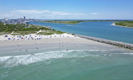 Jetty Park beach with a cruise ship passing in the background